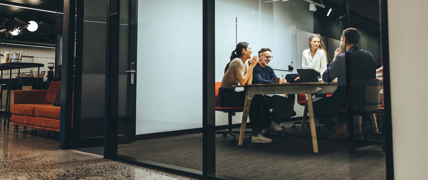 Side view of a group of people in a meeting space