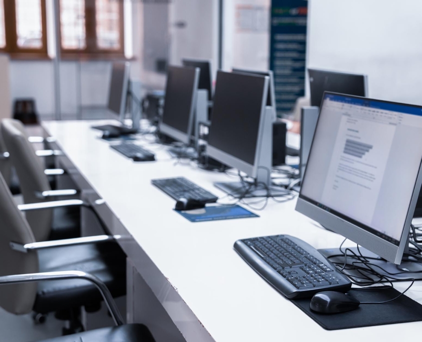 Row of office computers at desks