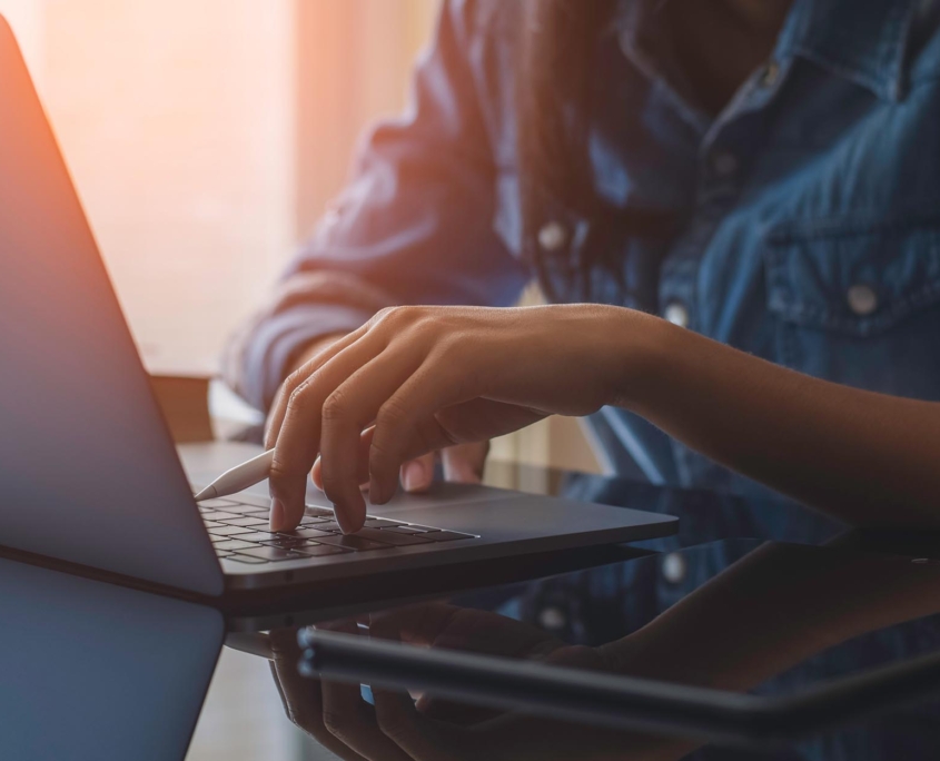 Side view of a worker looking at laptop